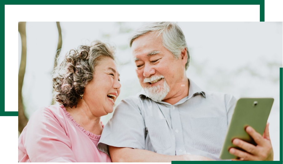 Broad Wealth Management - happy senior couple with their phone